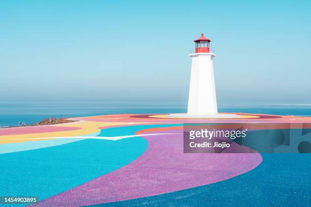 colorful road by the sea - lighthouse ストックフォトと画像