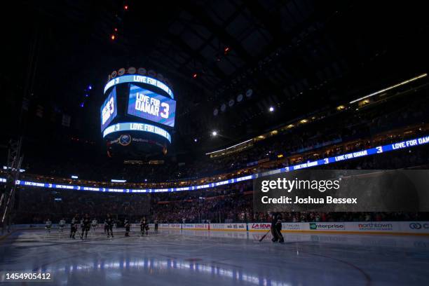 Buffalo Sabres and Minnesota Wild players pause for a moment before the game to honor Buffalo Bills safety Damar Hamlin before the first period of an...