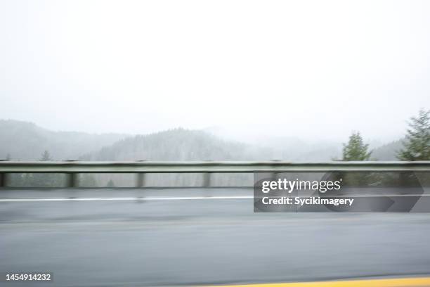 foggy landscape along highway - vägräcke bildbanksfoton och bilder