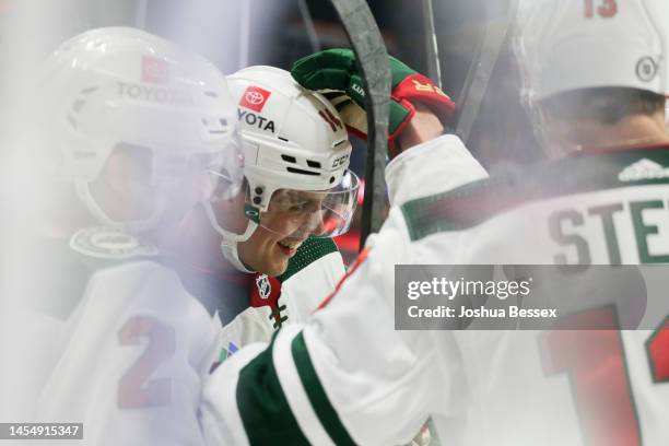 Joel Eriksson Ek of the Minnesota Wild celebrates with teammates after scoring a goal during the third period of an NHL hockey game against the...