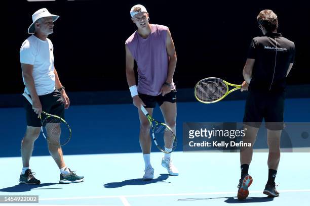 Holger Rune of Denmark speaks with Patrick Mouratoglou during a practice session ahead of the 2023 Australian Open at Melbourne Park on January 08,...