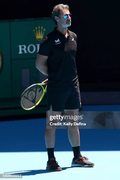 Patrick Mouratoglou looks on as Holger Rune of Denmark trains during a practice session ahead of the 2023 Australian Open at Melbourne Park on...