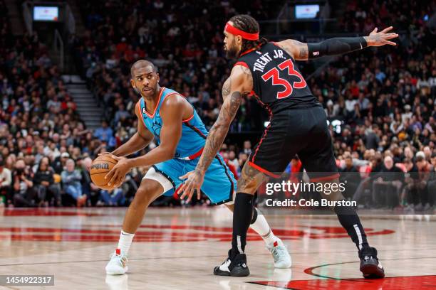 Chris Paul of the Phoenix Suns throws a pass around Gary Trent Jr. #33 of the Toronto Raptors during the second half of their NBA game at Scotiabank...