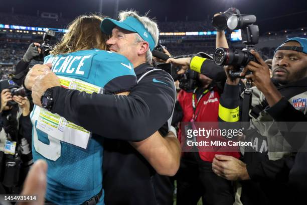 Head coach Doug Pederson of the Jacksonville Jaguars hugs Trevor Lawrence of the Jacksonville Jaguars after their 20-16 playoff clinching win against...