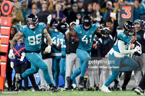 Adam Gotsis of the Jacksonville Jaguars and Arden Key of the Jacksonville Jaguars look to block while Josh Allen of the Jacksonville Jaguars returns...