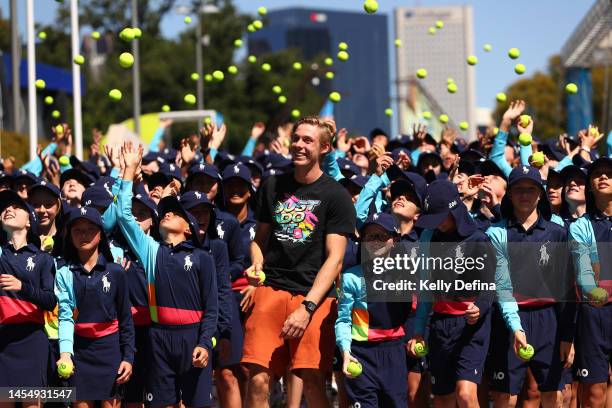 Denis Shapovalov of Canada poses with 2023 Australian Open ballkids during a media opportunity ahead of the 2023 Australian Open at Melbourne Park on...