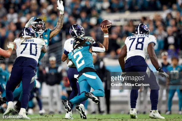 Joshua Dobbs of the Tennessee Titans fumbles the ball while being hit by Rayshawn Jenkins of the Jacksonville Jaguars during the fourth quarter at...