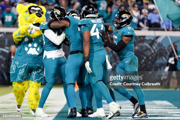 Josh Allen of the Jacksonville Jaguars celebrates with teammates after his fumble return for a go ahead touchdown during the fourth quarter against...