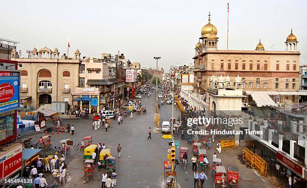 People walk in sparsely occupied Chandni Chowk area as the Bharatiya Janata Party called for "Nation Bandh", or a natiowide shutdown, to protest...