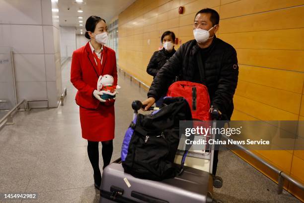 Staff member sends a rabbit toy to a passenger at Shanghai Pudong International Airport on January 8, 2023 in Shanghai, China....