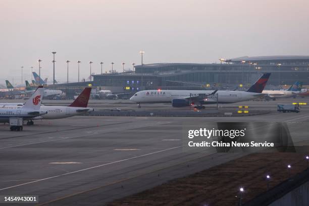 Delta Air Lines DL283 arrives at Shanghai Pudong International Airport on January 8, 2023 in Shanghai, China. Mandatory quarantine requirements and...