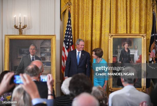 Former US First Lady Laura Bush and US President George W. BUsh unveil their official portraits on May 31, 2012 in the East Room of the White House...