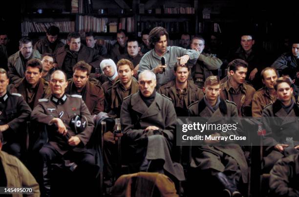 Hairdresser performs last-minute work on actor Sebastian Tillinger on the set of the film 'Hart's War', 2002. Also visible are actors Sam...