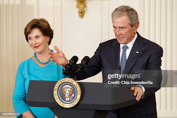 Former U.S. President George W. Bush and former first lady Laura Bush deliver remarks during their offical portraits unveiling ceremony in the East...