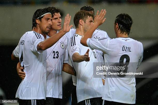 Mario Gomez of Germany celebrates with teammates Sami Khedira, Mesut Oezil, Jerome Boateng and Thomas Mueller after scoring his team's opening goal...