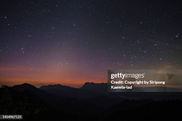 the starry night with zodiacal light over the peak of mt. doi luang chiang dao before sunrise. - zodiacal light stock pictures, royalty-free photos & images