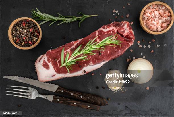 raw beef steak and spices on slate for cooking. - beef ribs stockfoto's en -beelden