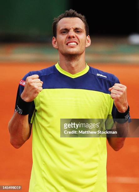 Paul-Henri Mathieu of France celebrates victory in his men's singles second round match against John Isner of USA during day 5 of the French Open at...
