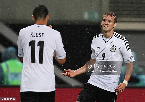 Andre Schuerrle of Germany celebrates with his team mate Miroslav Klose after scoring his team's second goal during the international friendly match...