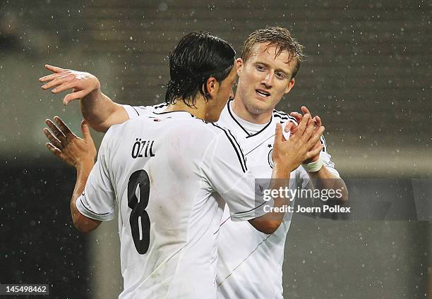 Andre Schuerrle of Germany celebrates with his team mate Mesut Oezil after scoring his team's second goal during the international friendly match...