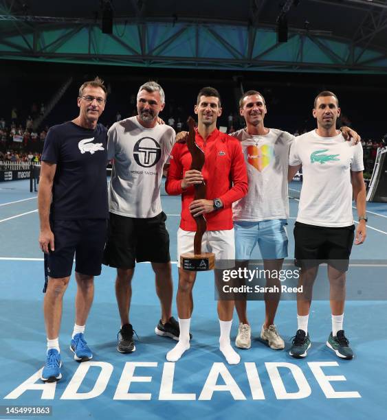 Novak Djokovic of Serbia wins the mens championship after defeating Sebastian Korda of the USA with his coaching staff during day eight of the 2023...