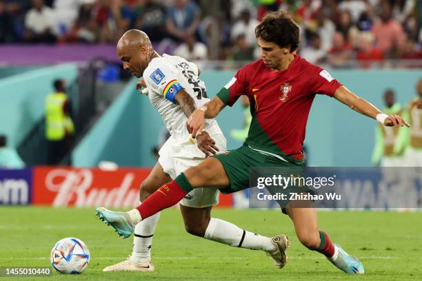 Joao Felix of Portugal competes for the ball with Andre Ayew of Ghana during the FIFA World Cup Qatar 2022 Group H match between Portugal and Ghana...