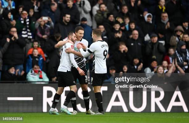 Tom Barkhuizen of Derby County celebrates with teammates Craig Forsyth and James Collins after scoring the team's second goal during the Emirates FA...