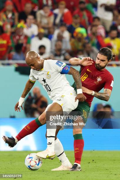 Andre Ayew of Ghana competes for the ball with Ruben Neves of Portugal during the FIFA World Cup Qatar 2022 Group H match between Portugal and Ghana...