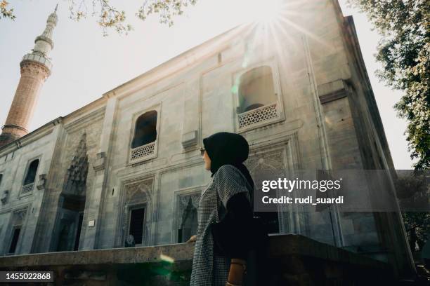 asian muslim woman looking and visit an ancient mosque in turkey - 布爾薩 土耳其 個照片及圖片檔