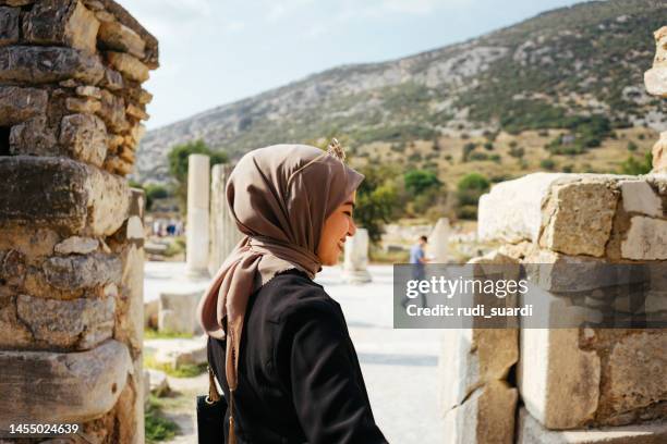 tourist woman enjoy exploring the ancient city of ephesus, - hijab woman from behind stock pictures, royalty-free photos & images