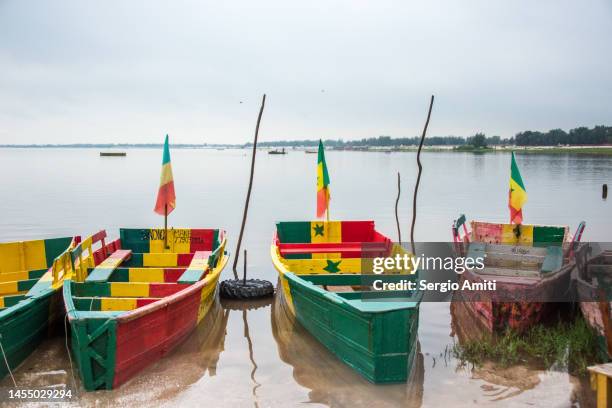 colourful wooden boats on lac rose - lake retba stock pictures, royalty-free photos & images