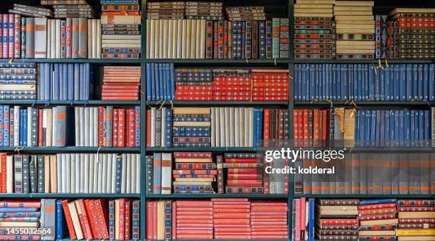 books on shelves, full frame of the bookshelf - libreria fotografías e imágenes de stock