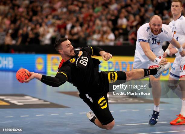 Jannik Kohlbacher of Germany challenges Arnar Arnarsson of Iceland during the handball international friendly match between Germany and Iceland at...