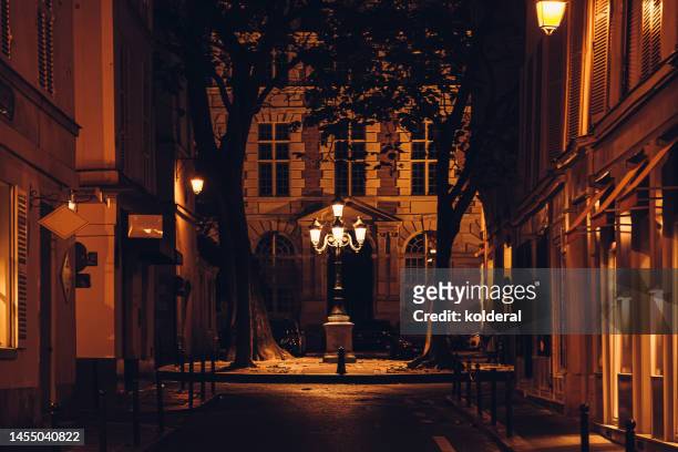 picturesque alley at night, historic district in paris, france - paris night stock pictures, royalty-free photos & images