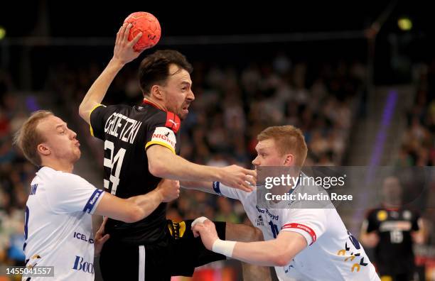 Patrick Groetzki of Germany challenge Hakon Styrmisson and Ymir Gislason of Iceland during the handball international friendly match between Germany...