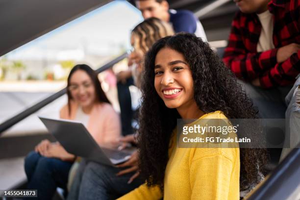 portrait of a young woman with her friends on university stairs - girl 18 stock pictures, royalty-free photos & images