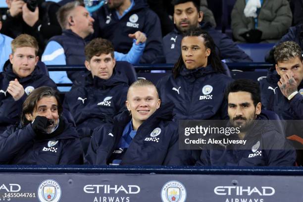Manchester City players look on from the bench during the Emirates FA Cup Third Round match between Manchester City and Chelsea at Etihad Stadium on...