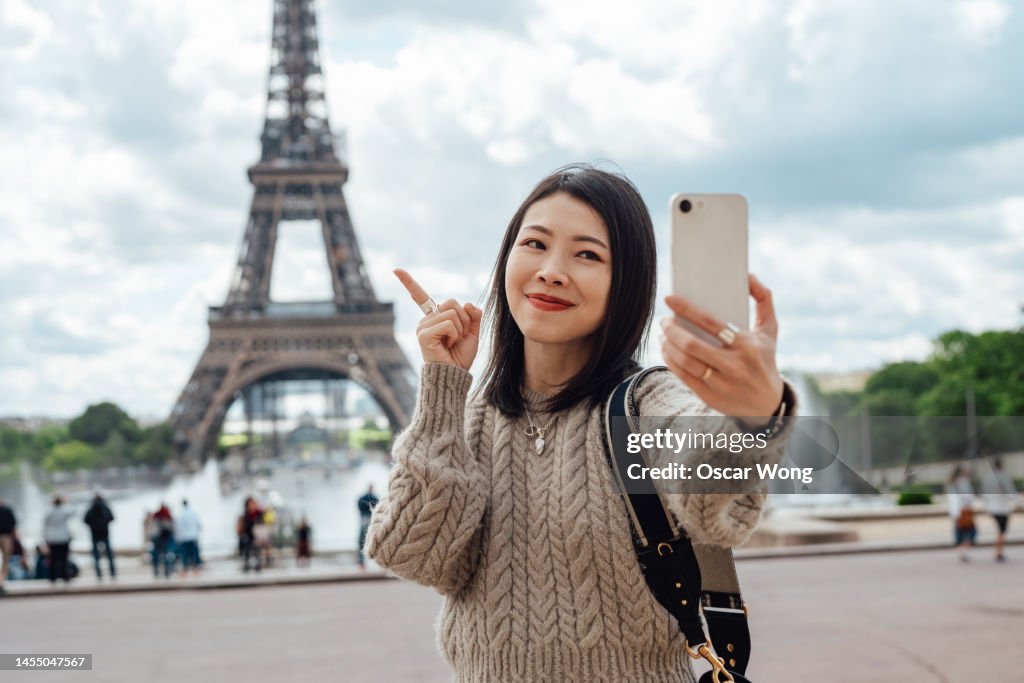 Travel influencer vlogging via smartphone while traveling in Europe