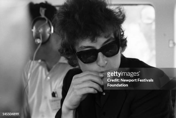 Singer songwriter Bob Dylan backstage before a performance at the Newport Folk Festival on July 25, 1965 in Newport, Rhode Island.