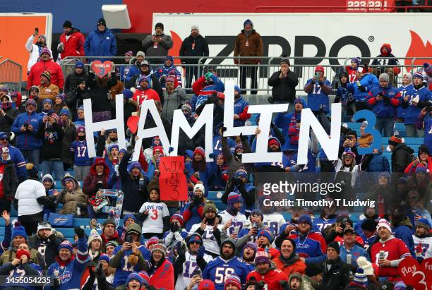 Buffalo Bills fans hold signs in support of Buffalo Bills safety Damar Hamlin prior to the game against the New England Patriots at Highmark Stadium...