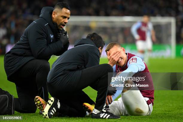 Ludwig Augustinsson of Aston Villa reacts as they receive medical treatment during the Emirates FA Cup Third Round match between Aston Villa and...