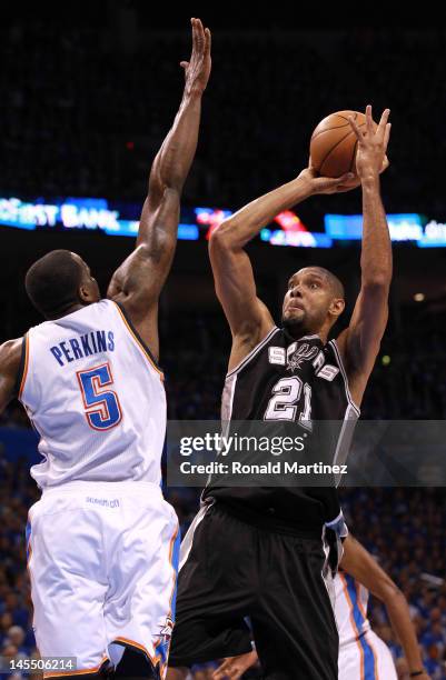 Tim Duncan of the San Antonio Spurs goes up for a shot against Kendrick Perkins of the Oklahoma City Thunder in the first quarter in Game Three of...