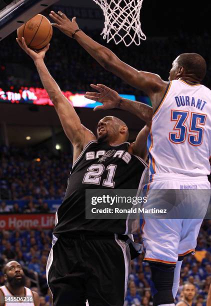 Tim Duncan of the San Antonio Spurs goes up for a shot against Kevin Durant of the Oklahoma City Thunder in the first quarter in Game Three of the...