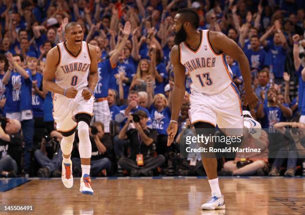 James Harden reacts after making a three-pointer alongside teammate Russell Westbrook of the Oklahoma City Thunder in the first half against the San...