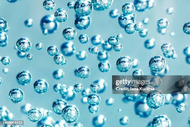 water, gel with bubbles. transparent blue moisture serum for face. hyaluronic acid. cosmetic products for makeup and skin care. beauty pattern. - zuurstof stockfoto's en -beelden