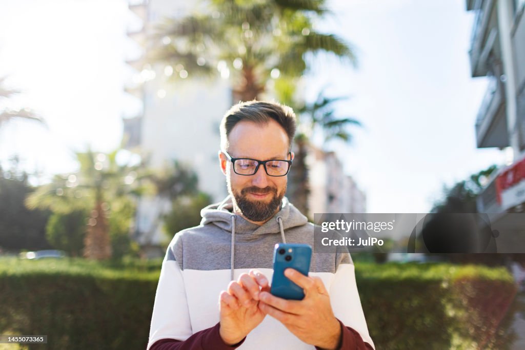 Man Using Mobile App Young Adult Men Using Mobile App At The Street High-Res Stock Photo ...