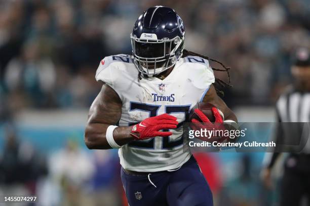 Derrick Henry of the Tennessee Titans carries the ball during the first half against the Jacksonville Jaguars at TIAA Bank Field on January 07, 2023...