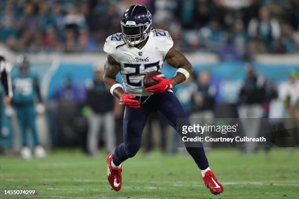 Derrick Henry of the Tennessee Titans carries the ball during the first half against the Jacksonville Jaguars at TIAA Bank Field on January 07, 2023...