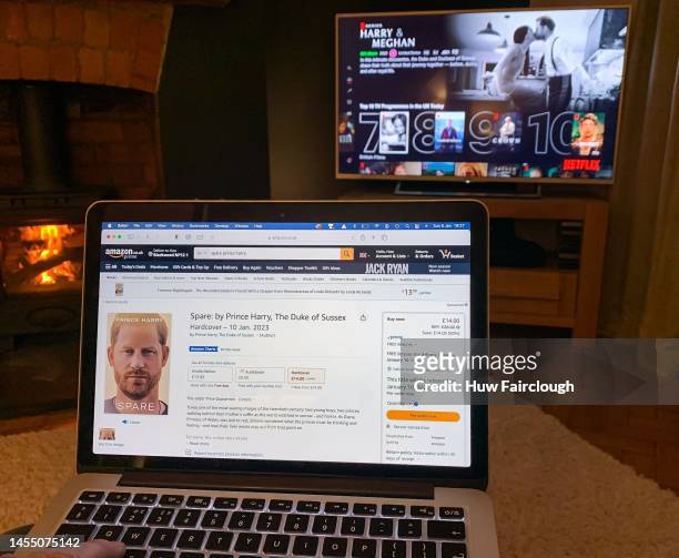 In this photo illustration, a customer browses Amazon for Prince Harry's Duke of Sussex memoirs, set to be published on January 10 as the Harry and...