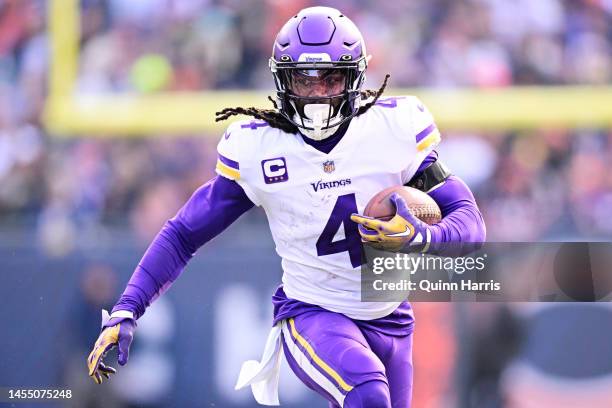 Running back Dalvin Cook of the Minnesota Vikings carries the ball during the game against the Chicago Bears at Soldier Field on January 08, 2023 in...